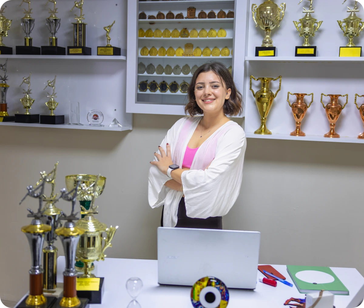 Woman smiling in trophy-filled office